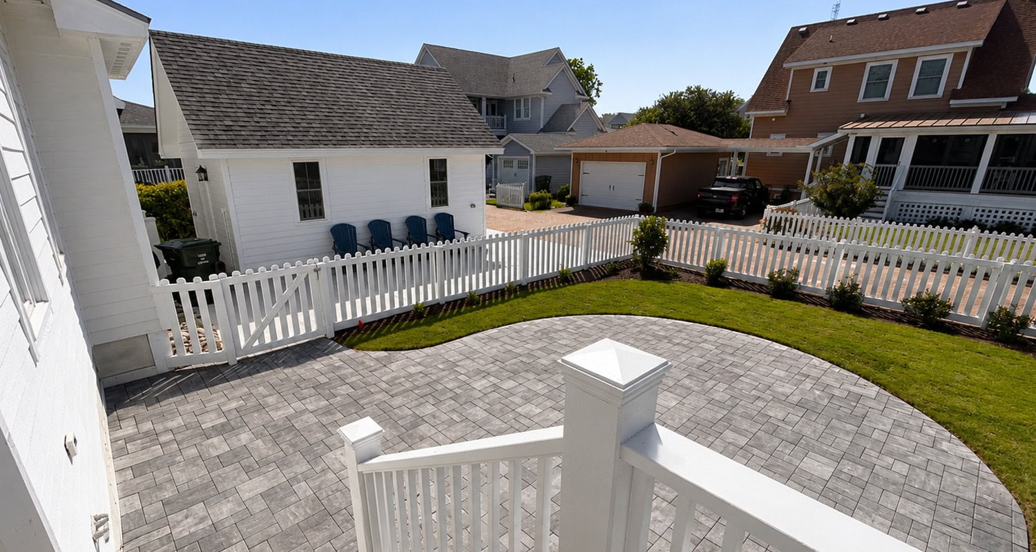 Residential landscaping projects featuring a paver patio and hardscaping within a fenced residential yard